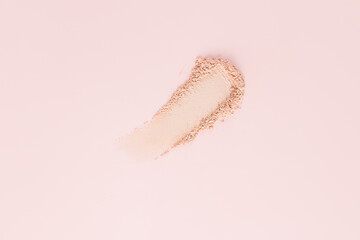 A beautiful brushstroke, a sample of a cosmetic product, powder, eyeshadow, highlighter with a shimmering shade of natural tone. A copy space. pastel