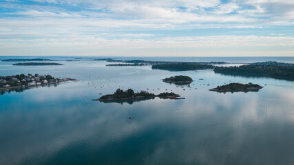 Aerial view of small islands in a calm bay with sailboats, Cape Cod, USA.