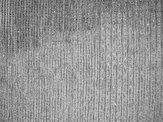 Textured fabric with a subtle pattern, showcasing a soft beige color.