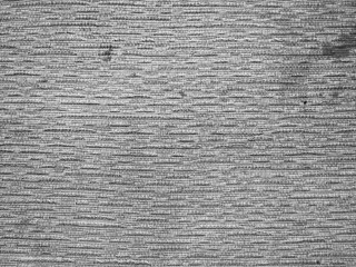 Textured fabric with a soft, muted gray color, featuring a subtle woven pattern.