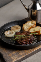 Grilled beef steak with rosemary and toasted baguette