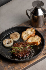 Grilled beef steak with rosemary and toasted baguette
