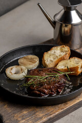 Grilled beef steak with rosemary and toasted baguette