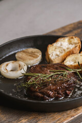 Grilled beef steak with rosemary and toasted baguette
