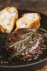 Grilled beef steak with rosemary and toasted baguette