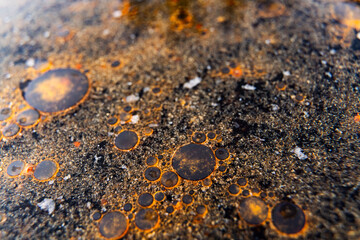 Close up macro shot of fat globules, fat droplets or grease spots in a frying pan - texture for computer graphics cgi, compositing and creative design