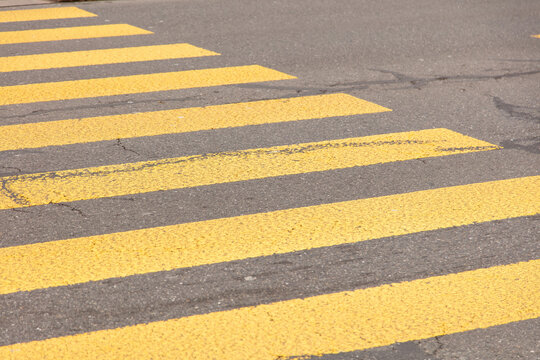 Pedestrian crossing, yellow color stripes crosswalk, closeup