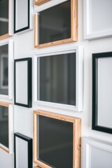 Diverse picture frames arranged on a white wall create a dynamic display of art and visual appeal.