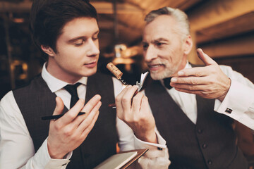 Experienced elegant sommelier tasting wine, inhaling vapors from decanter and wine. Wine tasting.