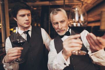 Two men sommelier tasting wine in restaurant. Tasting of elite drinks.