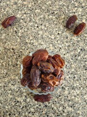 Dates in a bowl on a wooden background. Dried fruits. Dried date fruit. PNG, Ramadan. Organic dried medium fruit snack. Dried date palm.