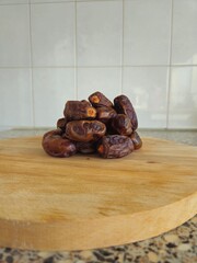 Dates in a bowl on a wooden background. Dried fruits. Dried date fruit. PNG, Ramadan. Organic dried medium fruit snack. Dried date palm.