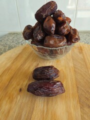 Dates in a bowl on a wooden background. Dried fruits. Dried date fruit. PNG, Ramadan. Organic dried...