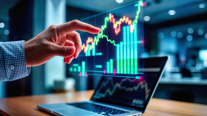 Fototapeta premium Financial market data on laptop screen with glowing chart and trader hand. Business investment analysis with digital graphs tracks economic growth, profit trends and trading analytics.