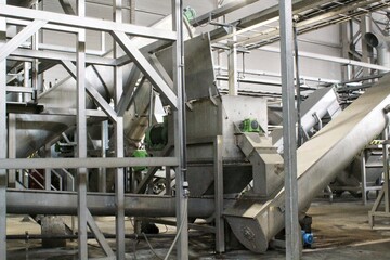 Sustainable brewing steel tanks and pipes in a modern facility for eco-friendly beer production. Industrial brewing equipment and clean brewing technology in a sustainable food processing environment