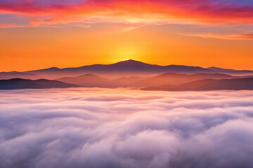 Vibrant sunrise over a mountain range, seen from above a sea of clouds.