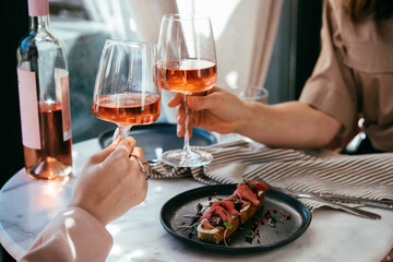 Glasses of rose wine seen during a friendly party or a celebration in a restaurant of a bar.