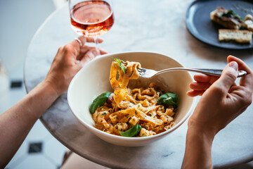 Having a pasta dinner at home or in a restaurant.