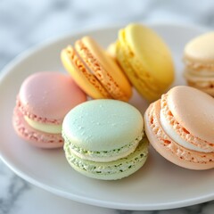 Obraz premium Professional stock photo of a Colorful macaron assortment in pastel shades on a white plate