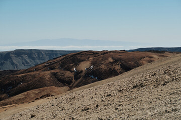Stunning panoramic view of a volcanic landscape. Rugged terrain, dramatic cliffs, and unique rock formations create a breathtaking vista. Ideal for travel, nature, and geology projects.Volcano Teide