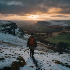 Obraz premium Rear view of man standing on mountain top during winter, Sunset & Sky