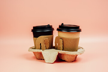 Take away coffee paper cup on pink background. Coffee go to