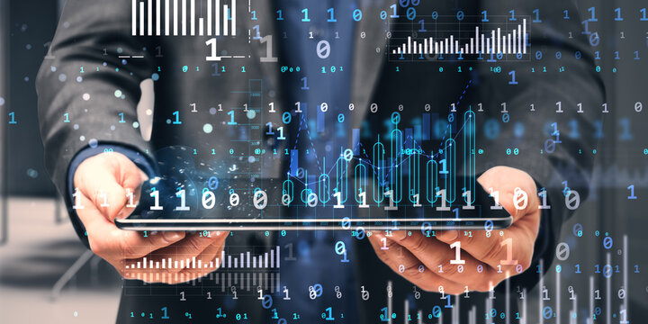 Businessman holding tablet with digital data hologram overlay. - Powered by Adobe