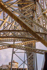 Sunlit Symmetry: The Intricate Ironwork of Dom Luis Bridge in Porto
