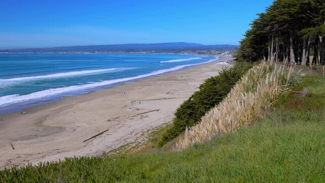 Beach, dunes, and grass with a coastal view and ocean waves in Aptos California USA