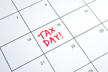 Close up shot of a calendar, with Tax Day reminder on the 15th. Deadline for filing Individual...