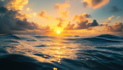Fototapeta premium Point Of View In The Ocean During Sunset With Gentle, Cumulus Clouds Radiating A Warm Yellow Glow.