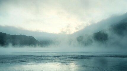 Foggy Mountain Lake View with Cloudy Sky and Water Reflections