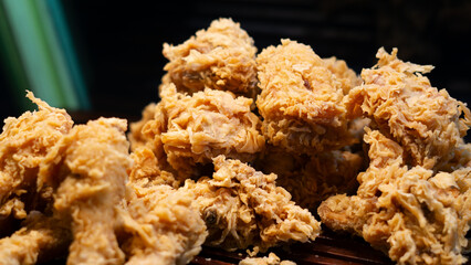 Crispy fried chicken drumsticks with a perfectly crunchy coating, freshly prepared at a bustling street vendor stall. A must-try for food lovers