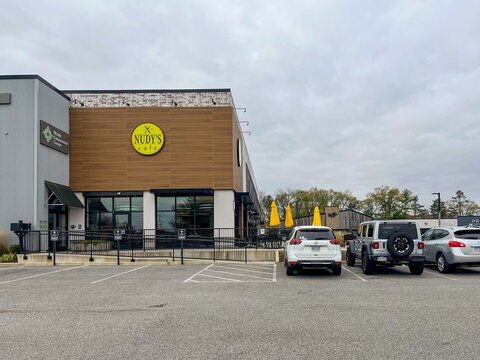 A Nudy's Cafe restaurant with a yellow sign on the front
