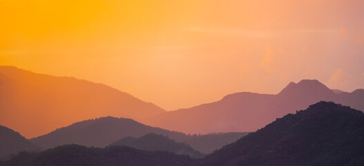 Beautiful sunrise misty mountain layers, silhouettes on the horizon