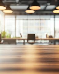 Modern workspace with wooden table and blurred chairs in a bright office environment during daylight hours