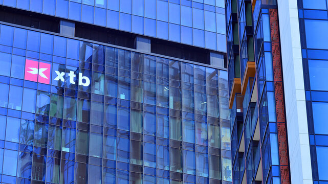 Warsaw, Poland. 22 February 2025. Urban landscape. XTB logo sign on glass wall. Company signboard XTB.