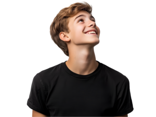 Young boy with joyful expression looking upwards, isolated on black background, smiling with hope and curiosity