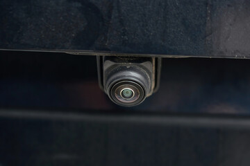 Scratched rear parking camera lens on car. Scratched and hazy rear parking camera lens, dirt, scuffs, and damage can reduce visibility and affect accuracy of vehicle parking sensors. Selective focus