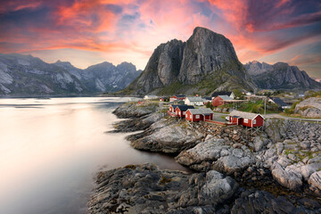 Beautiful sunrise over Hamnoy, fishermen village with the typical red houses of the Lofoten...
