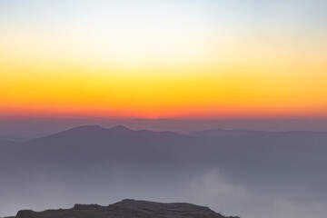 sunset from inside the clouds on the mountaintop, the air is shining