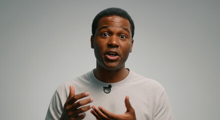 A man with a microphone on his shirt is talking to the camera