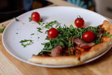 Deliciously Fresh Pizza Slice Topped with Cherry Tomatoes, Greens, and Aromatic Herbs