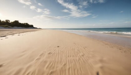 Wide-angle shot of a sea beach with a long stretch of sand and sky, soft focus, peaceful atmosphere