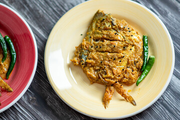 Spicy pabda fish curry gravy.