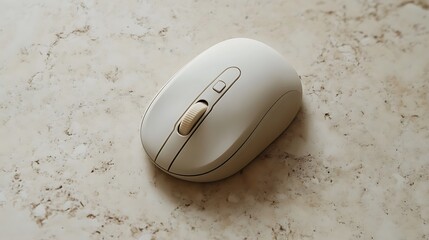 Beige wireless computer mouse on marble surface.