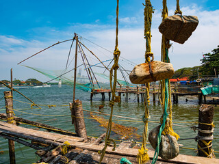 Chinese-style fishing nets, made from teak and bamboo, counterweighted by rocks, on the shoreline of Fort Kochi, a district of Kochi city in Kerala, southern India.