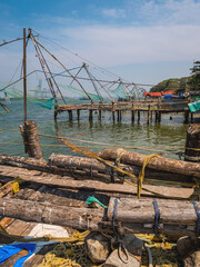 Chinese-style fishing nets, made from teak and bamboo, counterweighted by rocks, on the shoreline of Fort Kochi, a district of Kochi city in Kerala, southern India.