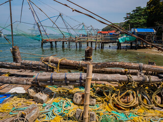 Chinese-style fishing nets, made from teak and bamboo, counterweighted by rocks, on the shoreline of Fort Kochi, a district of Kochi city in Kerala, southern India.