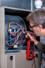 Electrician trouble shoots a new furnace install